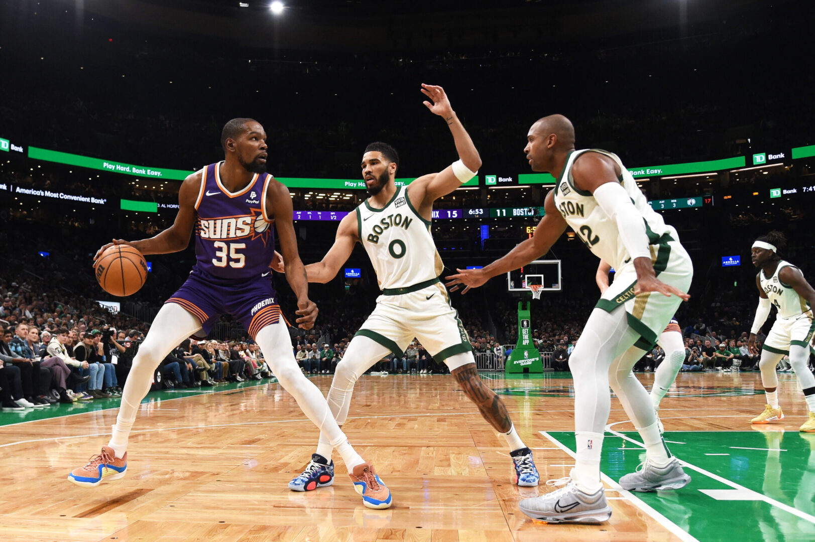 Mar 14, 2024; Boston, Massachusetts, USA; Phoenix Suns forward Kevin Durant (35) controls the ball while Boston Celtics forward Jayson Tatum (0) and center Al Horford (42) defend during the first half at TD Garden. Mandatory Credit: Bob DeChiara-Imagn Images