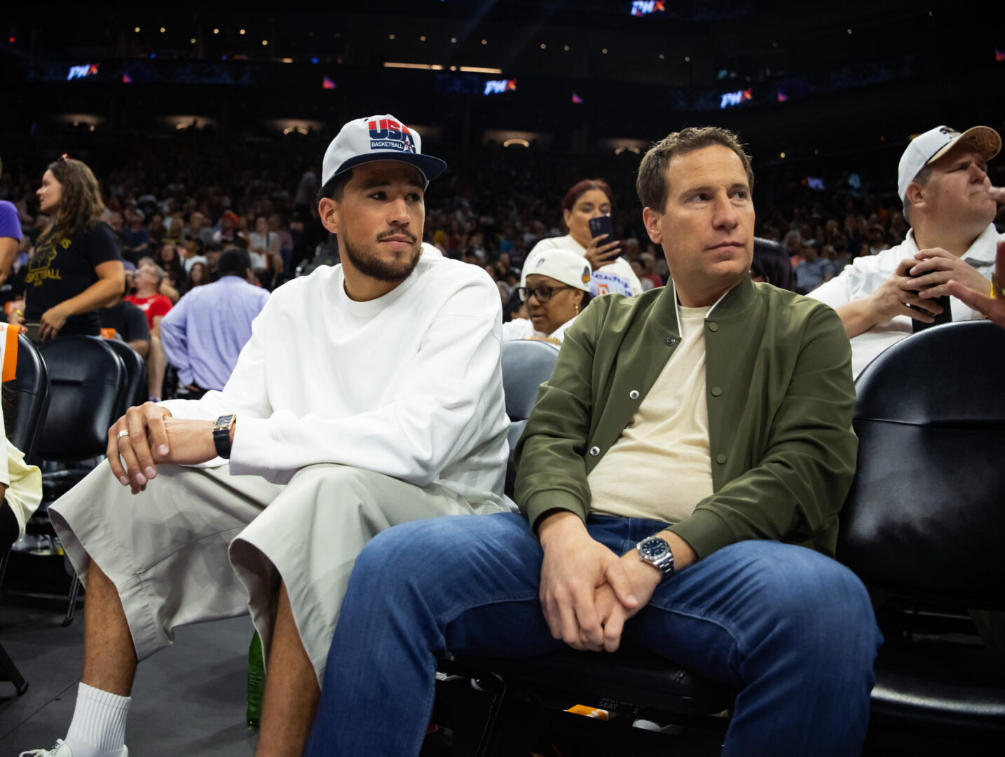 Jun 30, 2024; Phoenix, Arizona, USA; Phoenix Suns guard Devin Booker sits with Phoenix Mercury owner Mat Ishbia during the game between the Indiana Fever and the Phoenix Mercury at Footprint Center. Mandatory Credit: Mark J. Rebilas-Imagn Images