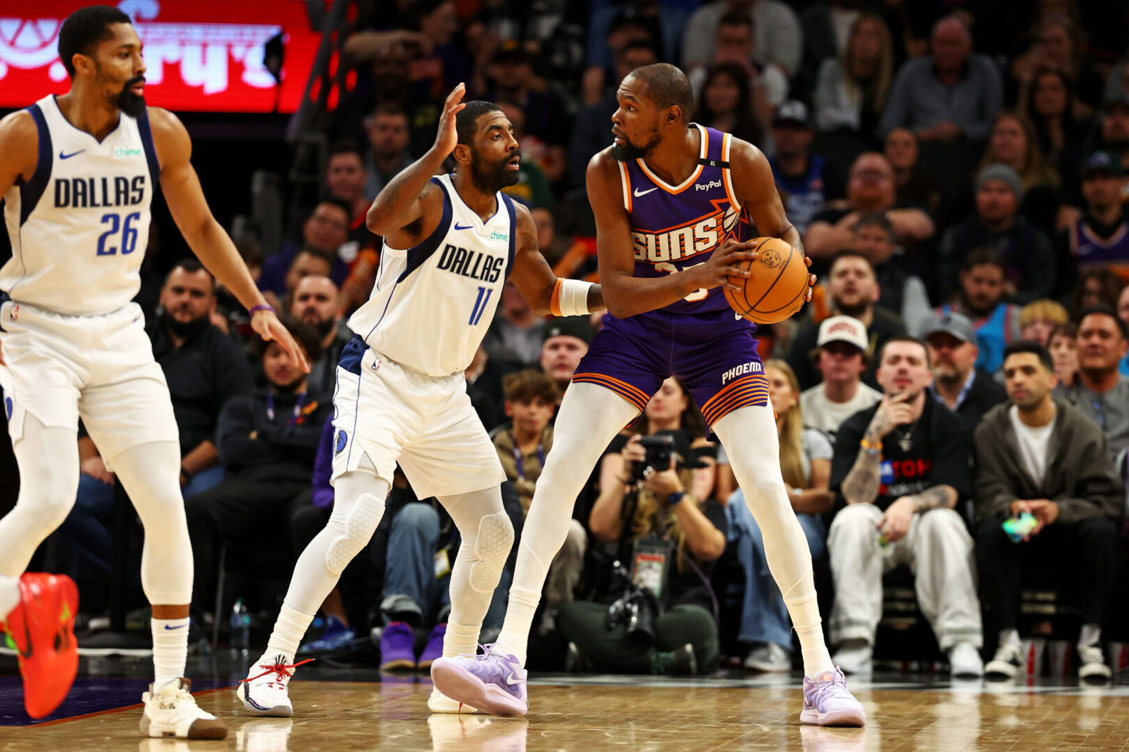 Dec 27, 2024; Phoenix, Arizona, USA; Phoenix Suns forward Kevin Durant (35) handles the ball against Dallas Mavericks guard Kyrie Irving (11) during the third quarter at Footprint Center. Mandatory Credit: Mark J. Rebilas-Imagn Images