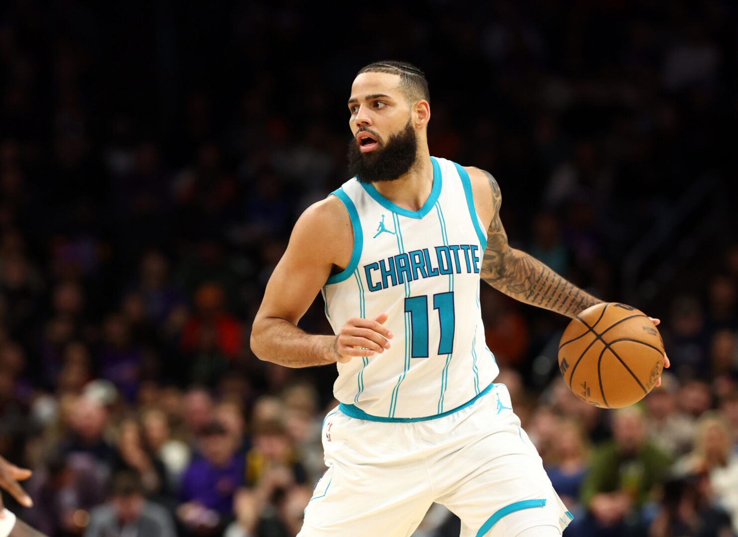 Jan 12, 2025; Phoenix, Arizona, USA; Charlotte Hornets forward Cody Martin (11) against the Phoenix Suns at Footprint Center. Mandatory Credit: Mark J. Rebilas-Imagn Images