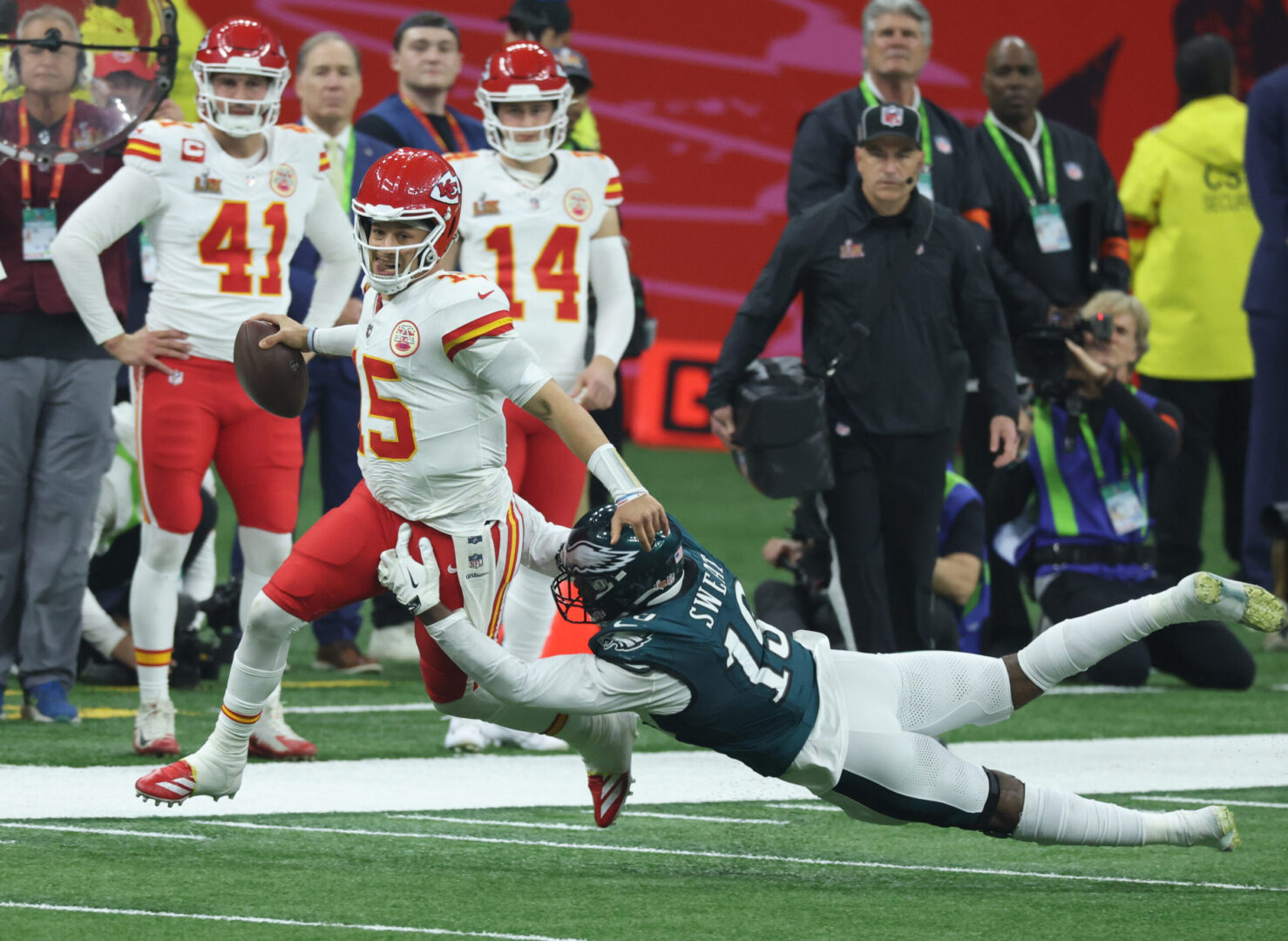 Feb 9, 2025; New Orleans, LA, USA; Kansas City Chiefs quarterback Patrick Mahomes (15) is tackled by Philadelphia Eagles linebacker Josh Sweat (19) in the second half in Super Bowl LIX between the Philadelphia Eagles and the Kansas City Chiefs at Ceasars Superdome. Mandatory Credit: Stephen Lew-Imagn Images