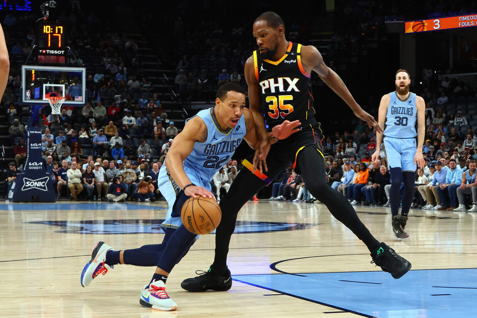 Mar 10, 2025; Memphis, Tennessee, USA; Memphis Grizzlies guard Desmond Bane (22) drives to the basket as Phoenix Suns forward Kevin Durant (35) defends during the first quarter at FedExForum. Mandatory Credit: Petre Thomas-Imagn Images
