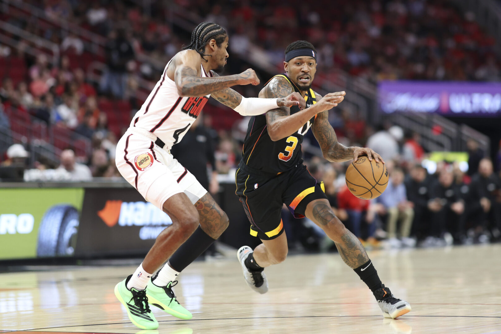 Mar 12, 2025; Houston, Texas, USA; Phoenix Suns guard Bradley Beal (3) dribbles the ball as Houston Rockets guard Jalen Green (4) defends during the first quarter at Toyota Center. Mandatory Credit: Troy Taormina-Imagn Images