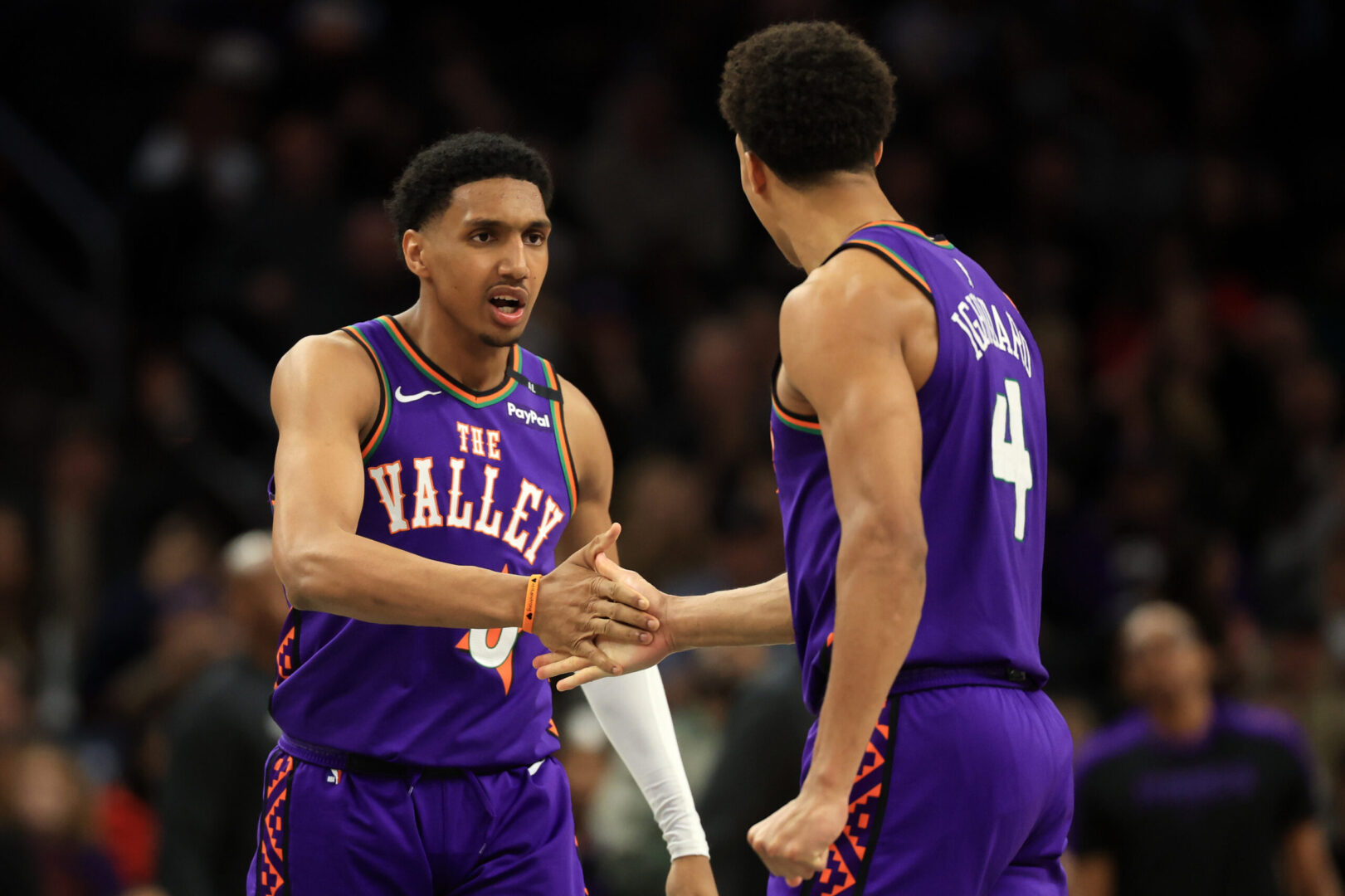 Mar 14, 2025; Phoenix, Arizona, USA; Phoenix Suns forward Ryan Dunn (0) reacts with center Oso Ighodaro (4) during the second half against the Sacramento Kings at Footprint Center. Mandatory Credit: Mark J. Rebilas-Imagn Images