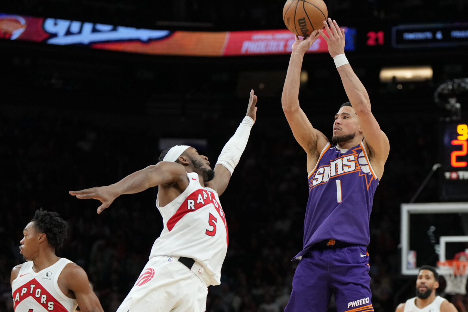 Mar 17, 2025; Phoenix, Arizona, USA; Phoenix Suns guard Devin Booker (1) shoots over Toronto Raptors guard Immanuel Quickley (5) in the second half at Footprint Center. Mandatory Credit: Rick Scuteri-Imagn Images