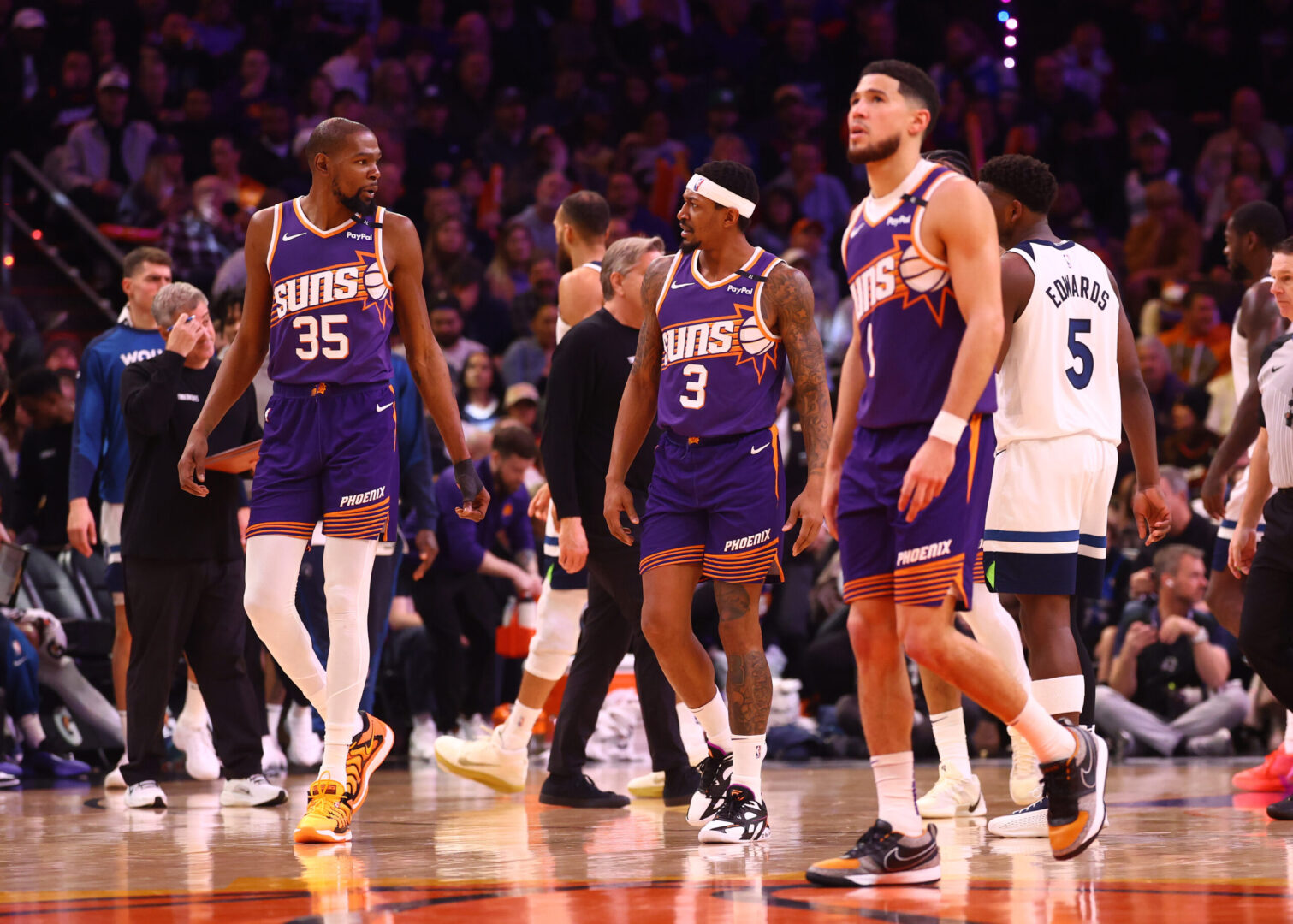 Jan 29, 2025; Phoenix, Arizona, USA; Phoenix Suns forward Kevin Durant (35) with guard Bradley Beal (3) and Devin Booker (1) against the Minnesota Timberwolves at Footprint Center. Mandatory Credit: Mark J. Rebilas-Imagn Images