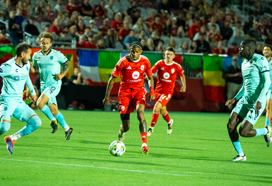 Phoenix Rising's Jearl Margaritha dribbles the ball past Monterey Bay FC defenders on May 17, 2025. Credits - @jpshooots on Instagram