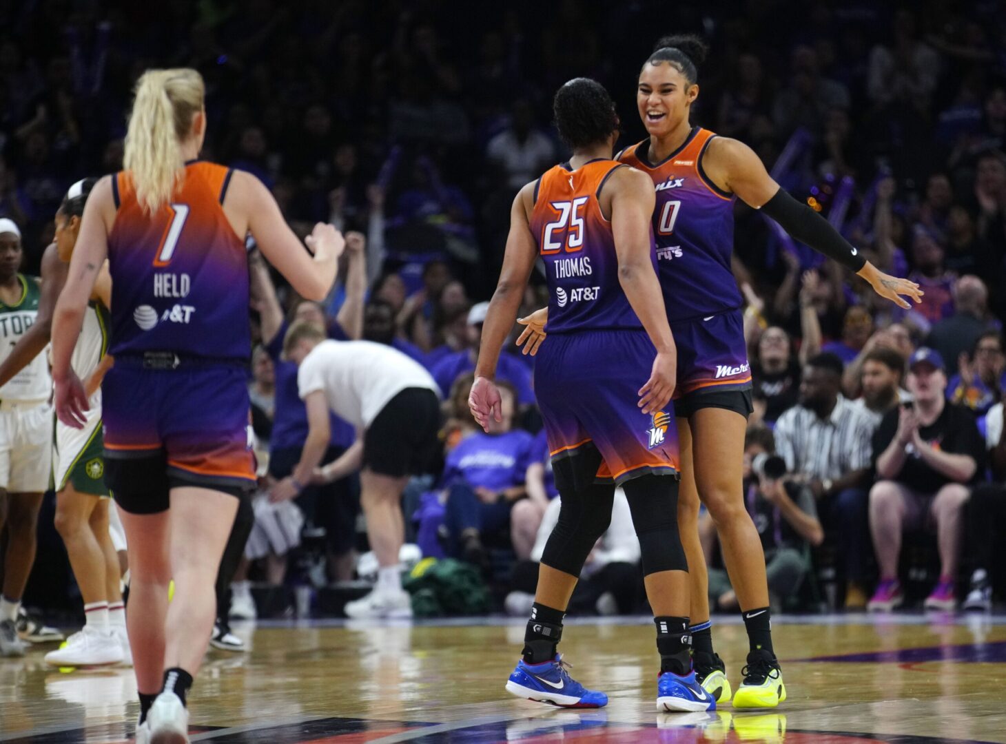 Phoenix Mercury forwards Satou Sabally and Alyssa Thomas and guard Lexi Held celebrate after forcing a Seattle Storm timeout on May 17, 2025. © Patrick Breen/The Republic / USA TODAY NETWORK via Imagn Images