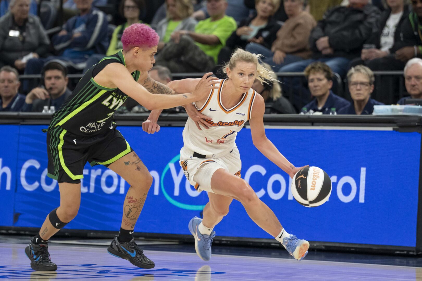Phoenix Mercury guard Lexi Held dribbles the ball around Minnesota Lynx guard Natisha Hiedeman on June 3, 2025. Credit: Jesse Johnson-Imagn Images