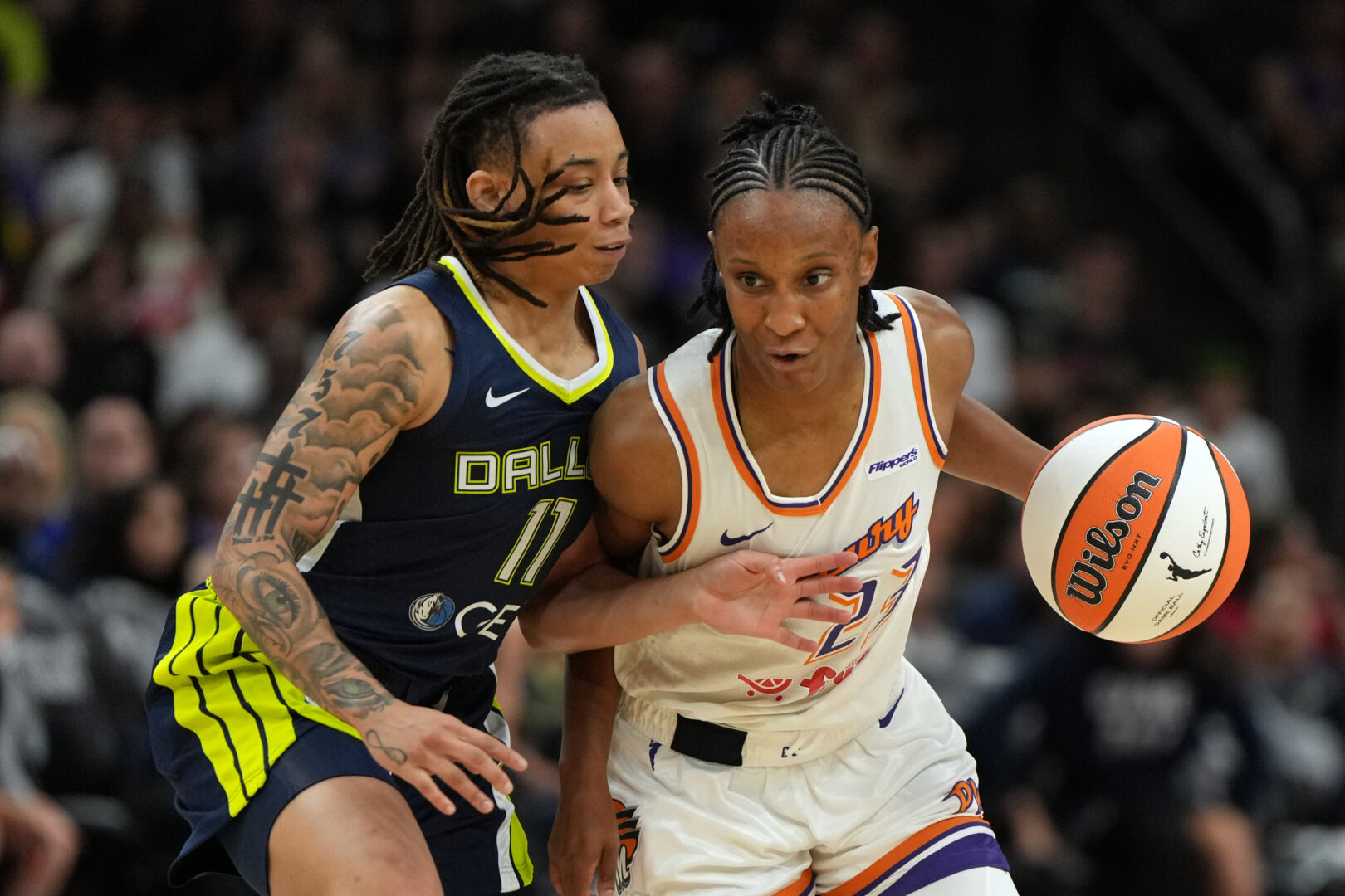 Jul 7, 2025; Phoenix, Arizona, USA; Phoenix Mercury guard Kiana Williams drives on Dallas Wings guard JJ Quinerly (11) in the second half at Footprint Center. Mandatory Credit: Rick Scuteri-Imagn Images
