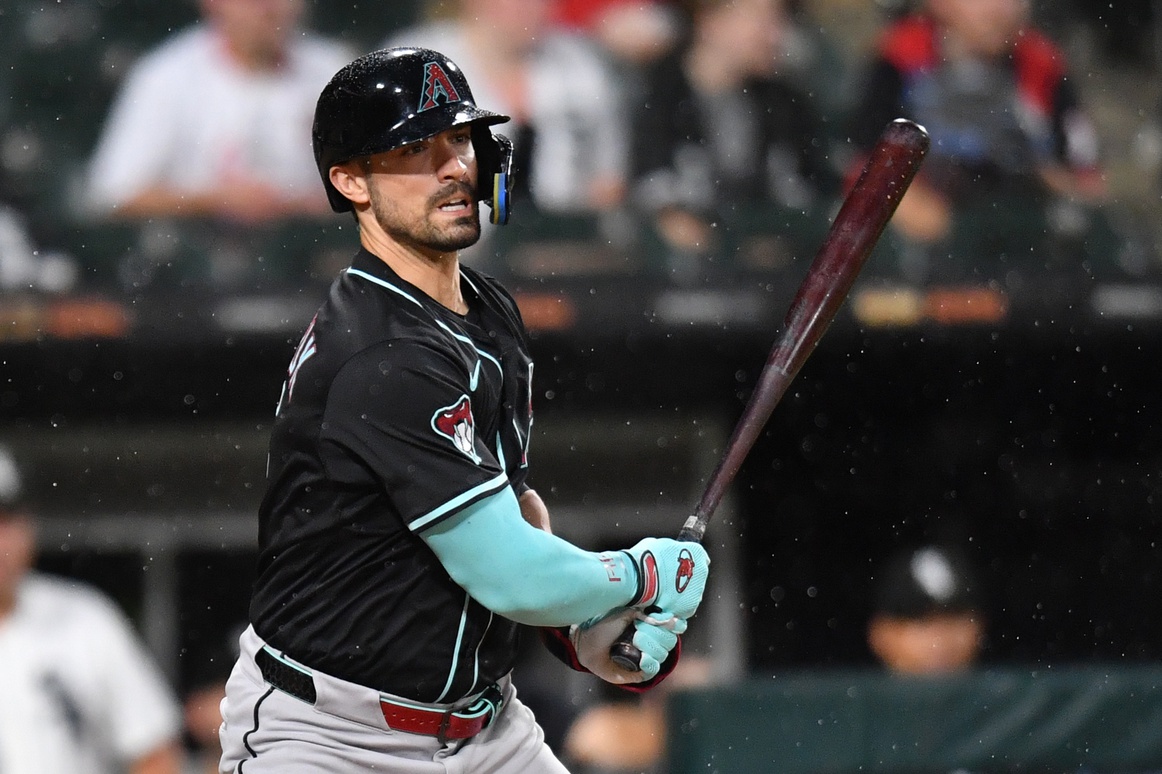 Jun 24, 2025; Chicago, Illinois, USA; Arizona Diamondbacks designated hitter Randal Grichuk (15) hits a single during the seventh inning against the Chicago White Sox at Rate Field. Mandatory Credit: Patrick Gorski-Imagn Images