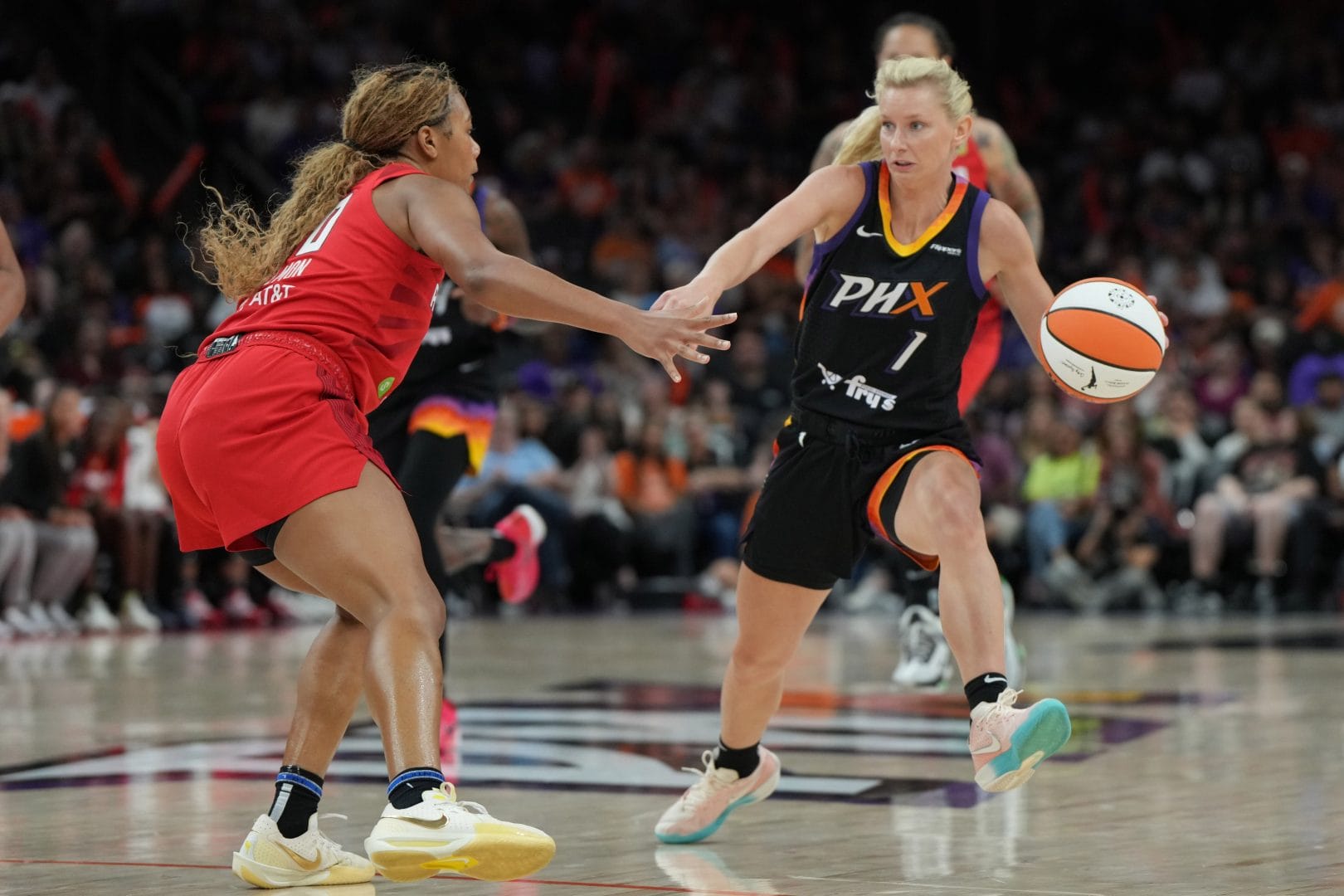 Jul 23, 2025; Phoenix, Arizona, USA; Phoenix Mercury guard Lexi Held (1) drives on Atlanta Dream forward Naz Hillmon (0) in the second half at Footprint Center. Mandatory Credit: Rick Scuteri-Imagn Images