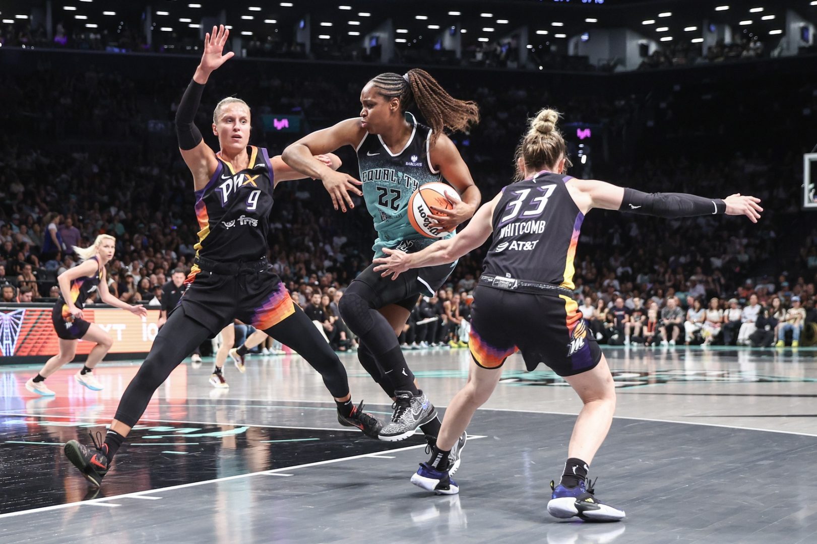 Jul 25, 2025; Brooklyn, New York, USA; New York Liberty forward Kennedy Burke (22) looks to drive past Phoenix Mercury guards Kitija Laksa (9) and Sami Whitcomb (33) in the first quarter at Barclays Center. Mandatory Credit: Wendell Cruz-Imagn Images