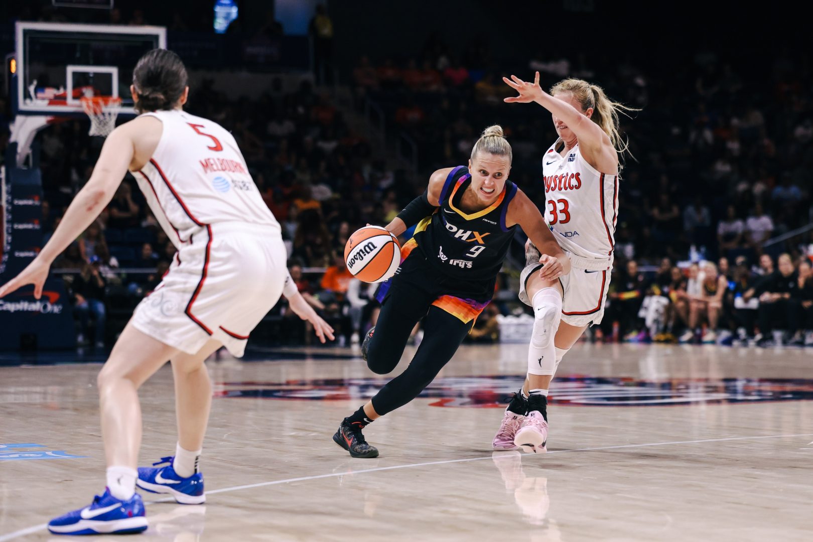 Jul 27, 2025; Washington, District of Columbia, USA; Phoenix Mercury guard Kitija Laksa (9) dribbles the ball while Washington Mystics guard Lucy Olsen (33) defends in the fourth quarter at CareFirst Arena. Mandatory Credit: Emily Faith Morgan-Imagn Images
