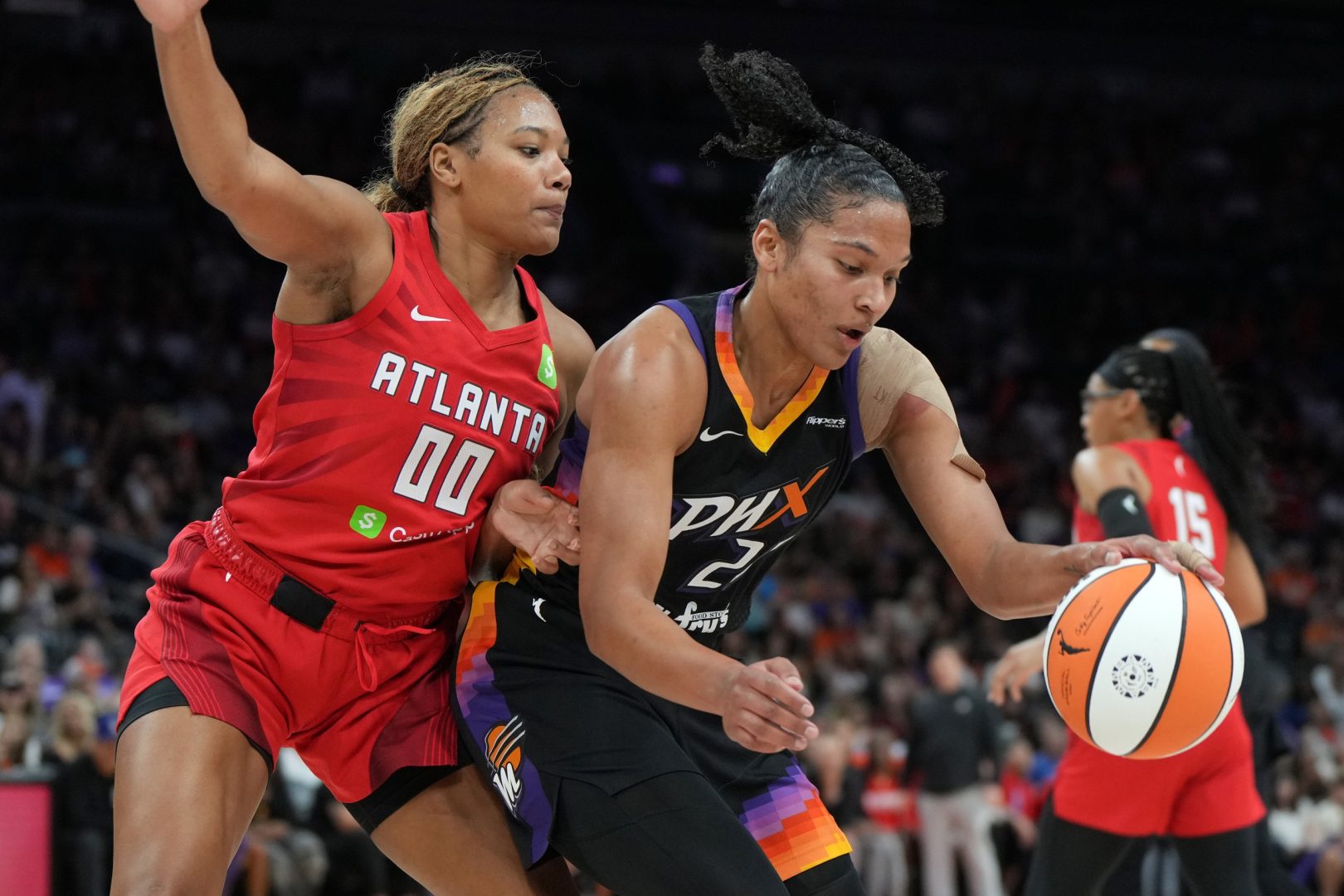 Jul 23, 2025; Phoenix, Arizona, USA; Phoenix Mercury forward Alyssa Thomas (25) drives on Atlanta Dream forward Naz Hillmon (0) in the second half at Footprint Center. Mandatory Credit: Rick Scuteri-Imagn Images