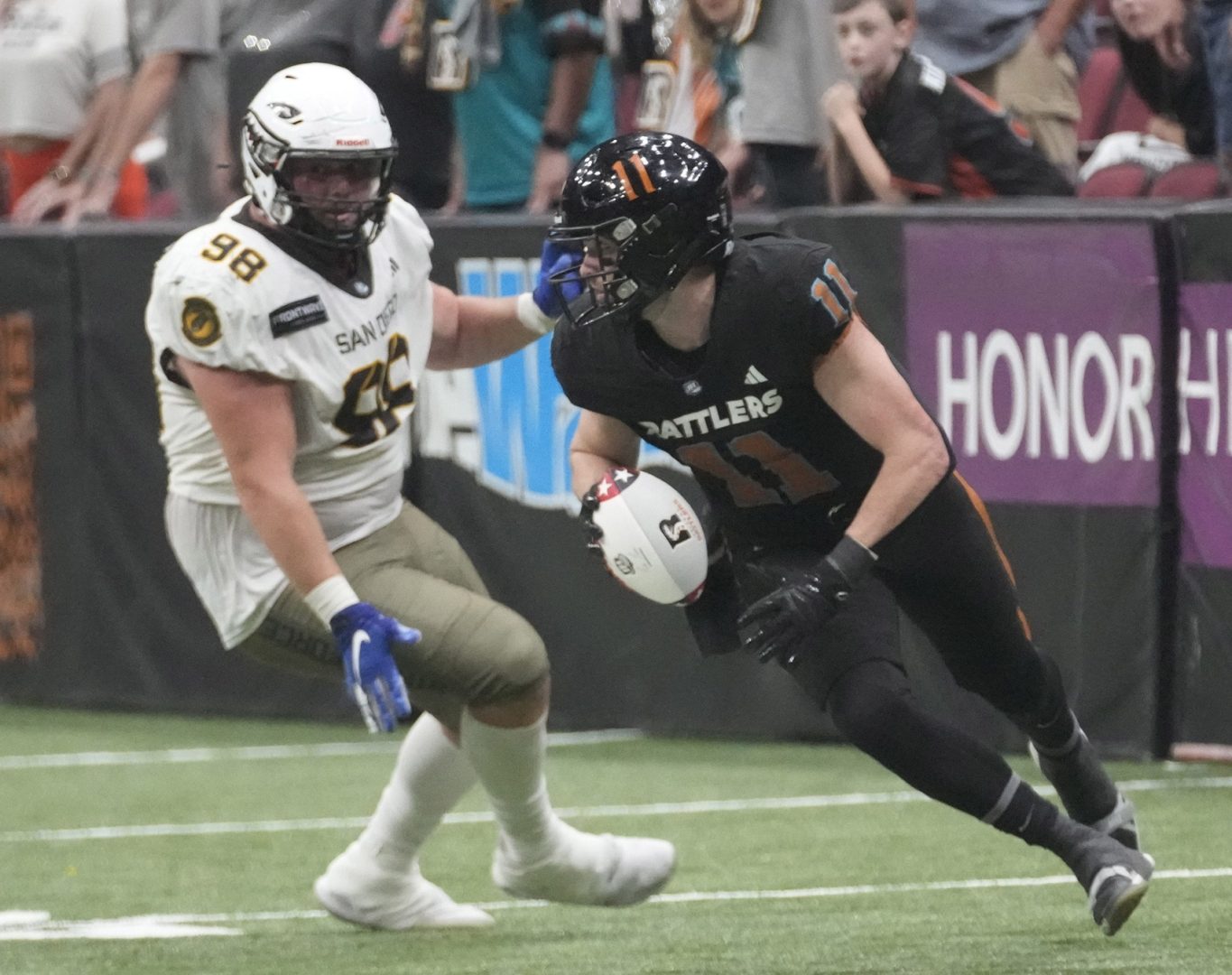 Arizona Rattlers QB Dalton Sneed (11) scrambles away from San Diego Strike Force DL Jackson Cravens (98) during the Indoor Football League first-round playoff game at Desert Diamond Arena on Aug. 4, 2025. © Michael Chow/The Republic / USA TODAY NETWORK via Imagn Images