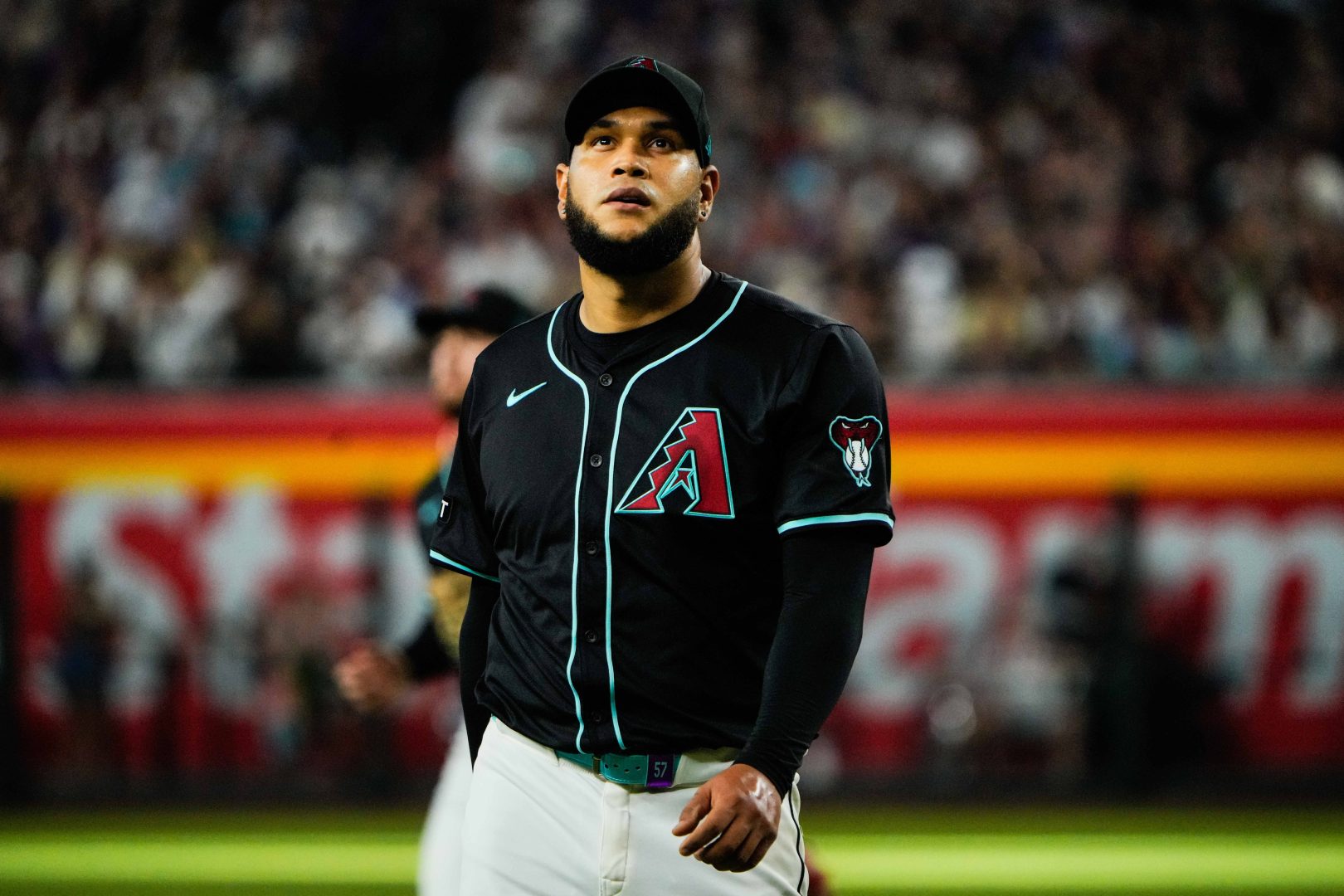 Aug 9, 2025; Phoenix, Arizona, USA; Arizona Diamondbacks pitcher Eduardo Rodriguez (57) reacts in the first inning of the game between the Arizona Diamondbacks and Colorado Rockies at Chase Field. Mandatory Credit: Arianna Grainey-Imagn Images