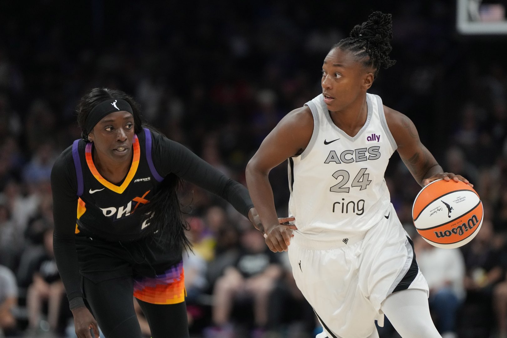 Aug 15, 2025; Phoenix, Arizona, USA; Las Vegas Aces guard Jewell Loyd (24) drives on Phoenix Mercury guard Kahleah Copper (2) in the first half at Footprint Center. Mandatory Credit: Rick Scuteri-Imagn Images