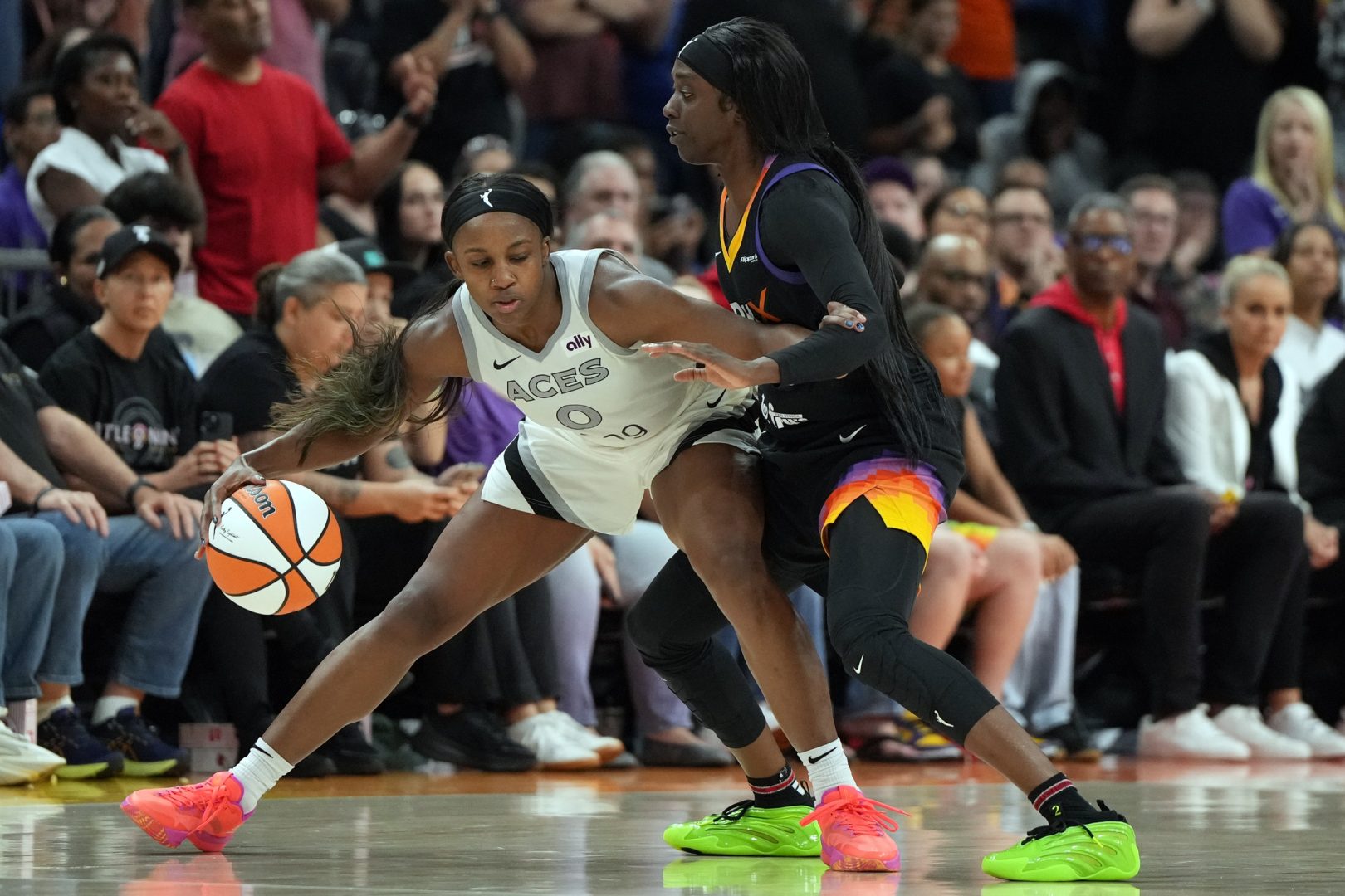 Aug 15, 2025; Phoenix, Arizona, USA; Las Vegas Aces guard Jackie Young (0) shields the ball from Phoenix Mercury guard Kahleah Copper (2) in the second half at Footprint Center. Mandatory Credit: Rick Scuteri-Imagn Images