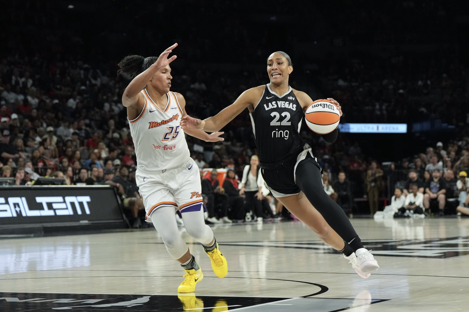 Aug 21, 2025; Las Vegas, Nevada, USA; Las Vegas Aces center A'ja Wilson (22) dribbles against Phoenix Mercury forward Alyssa Thomas (25) in the third quarter of their game at Michelob Ultra Arena. Mandatory Credit: Candice Ward-Imagn Images