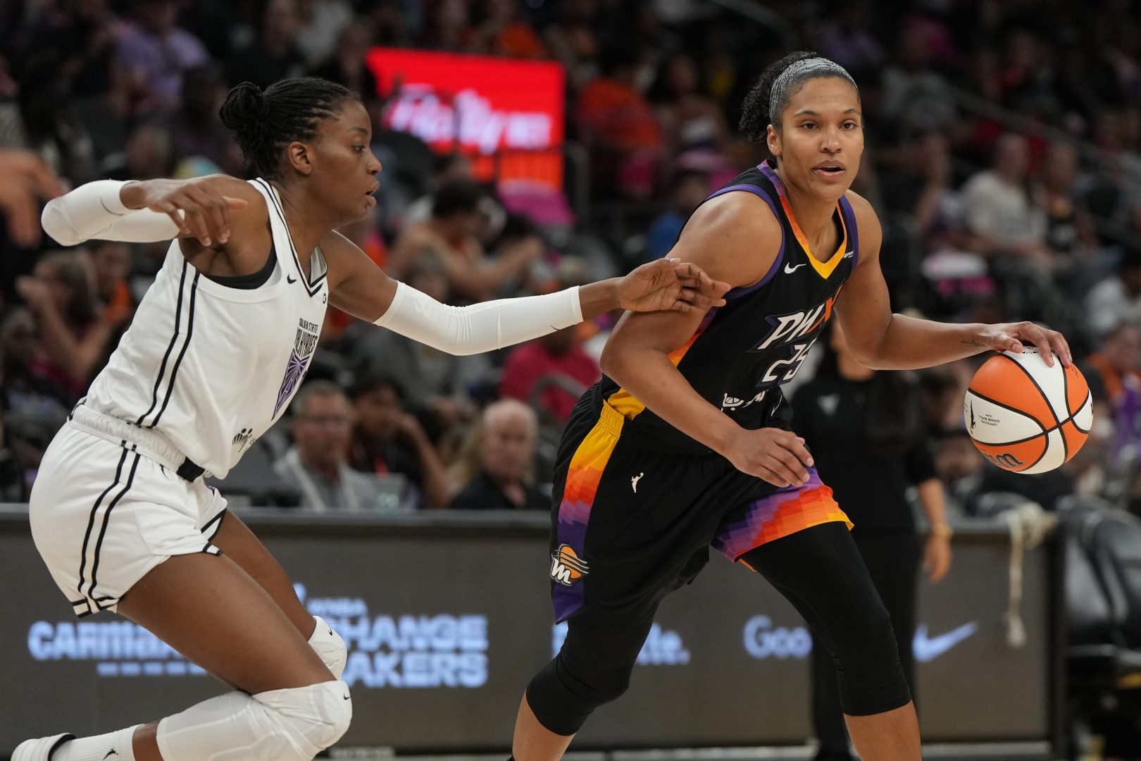 Aug 22, 2025; Phoenix, Arizona, USA; Phoenix Mercury forward Alyssa Thomas (25) drives around Golden State Valkyries center Temi Fagbenle (14) in the second half at Footprint Center. Mandatory Credit: Rick Scuteri-Imagn Images
