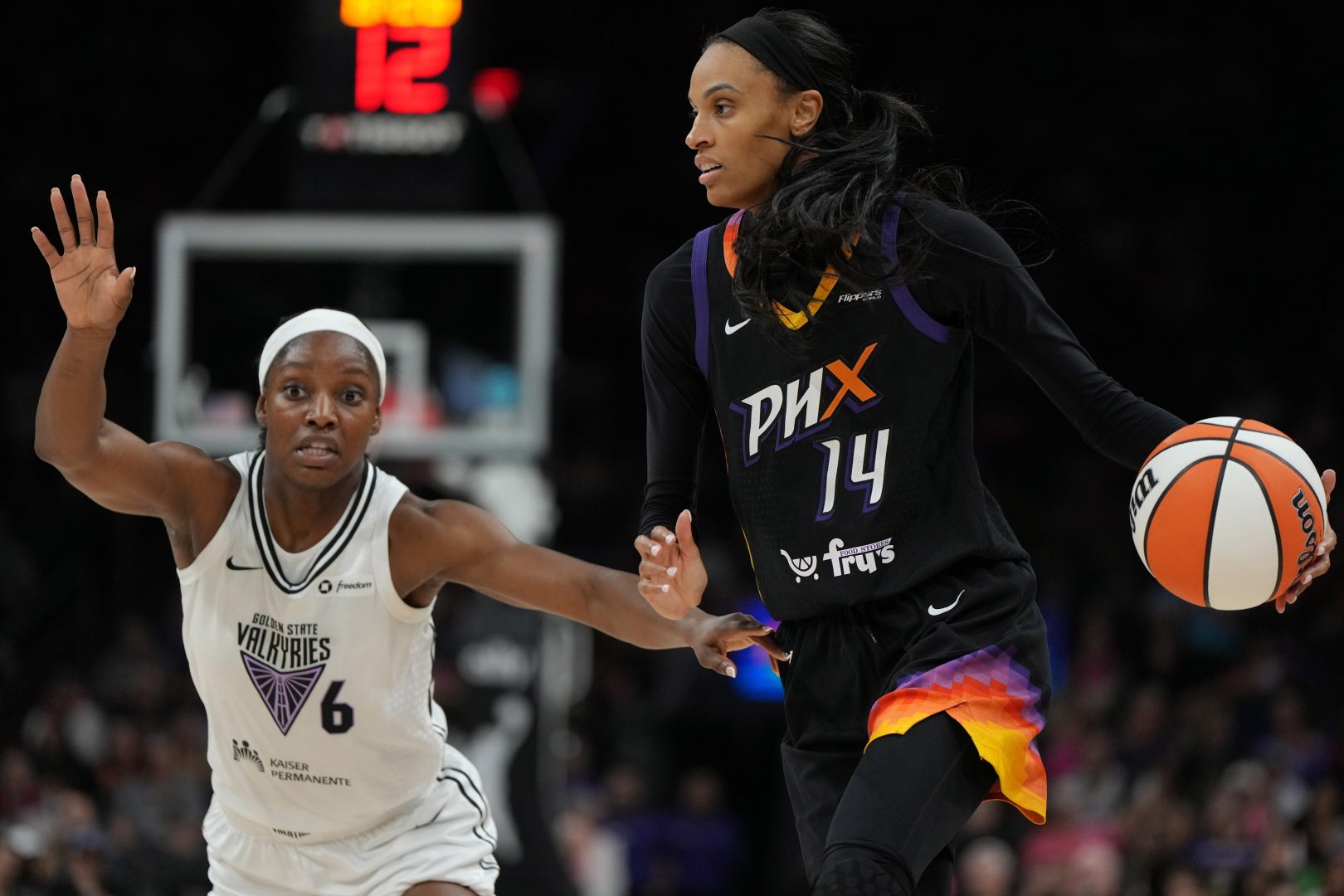Aug 22, 2025; Phoenix, Arizona, USA; Golden State Valkyries center Temi Fagbenle (14) drives on Golden State Valkyries guard Kaila Charles (6) in the second half at Footprint Center. Mandatory Credit: Rick Scuteri-Imagn Images