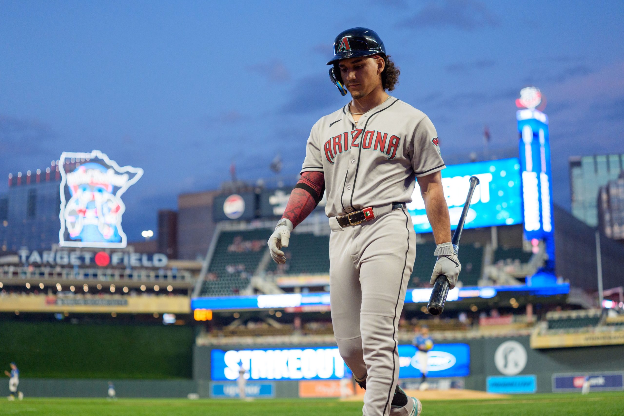 Sep 12, 2025; Minneapolis, Minnesota, USA; Arizona Diamondbacks center fielder Alek Thomas (5) walks to the dugout after striking out to Minnesota Twins starting pitcher Pablo Lopez (49) in the second inning at Target Field. Mandatory Credit: Matt Blewett-Imagn Images