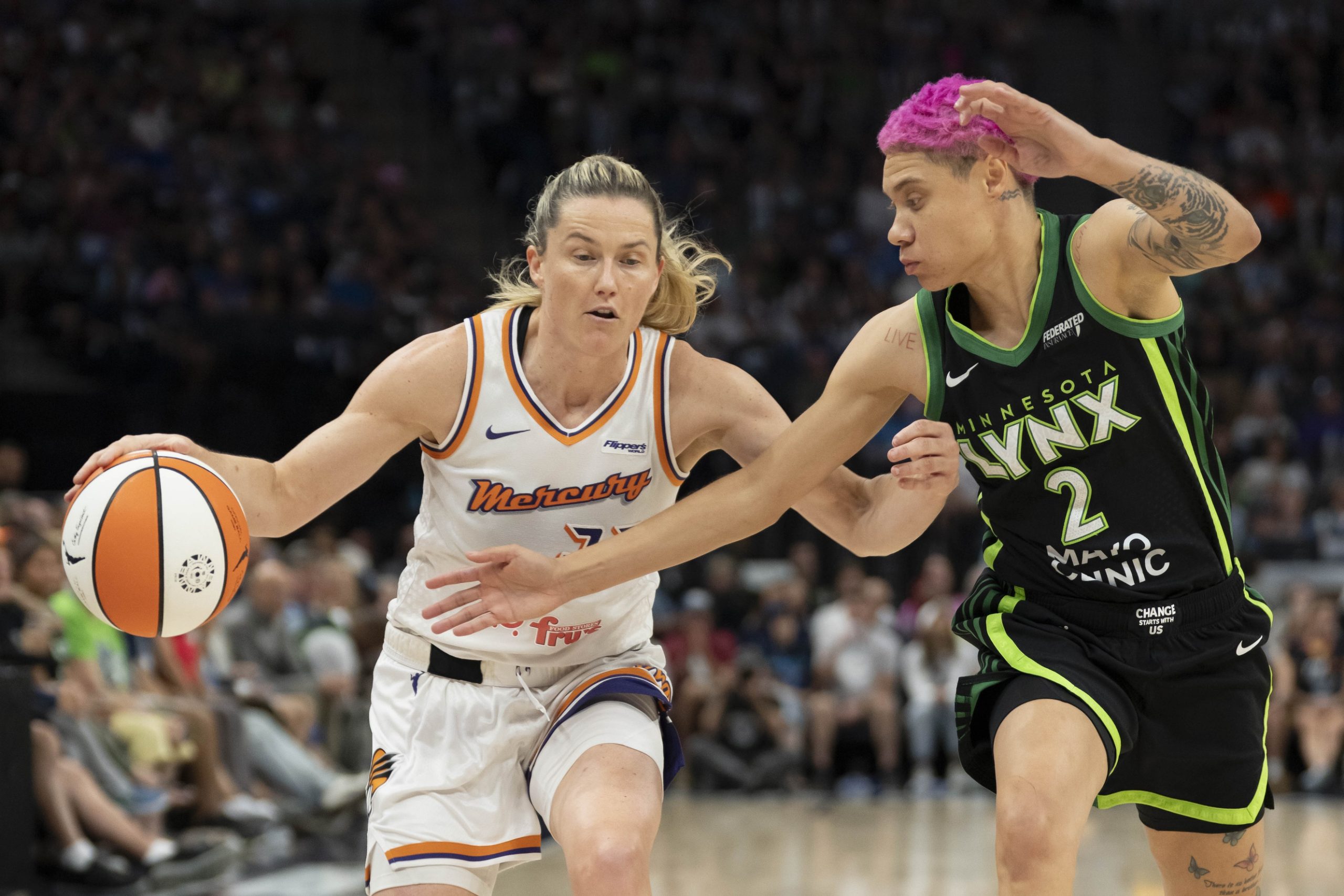 Sep 21, 2025; Minneapolis, Minnesota, USA; Phoenix Mercury guard Sami Whitcomb (33) dribbles the ball past Minnesota Lynx guard Natisha Hiedeman (2) in the second half during game one of the second round for the 2025 WNBA Playoffs at Target Center. Mandatory Credit: Jesse Johnson-Imagn Images