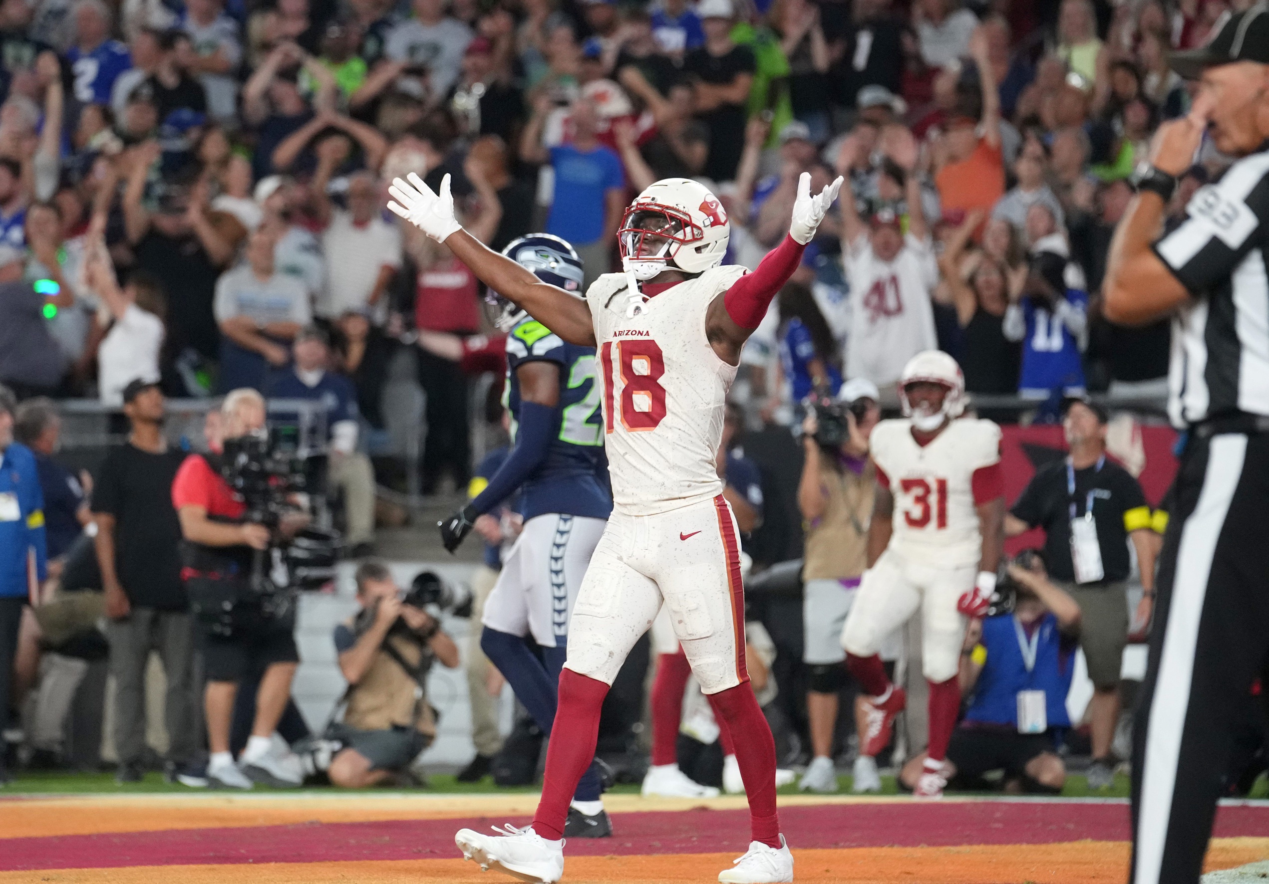Arizona Cardinals receiver Marvin Harrison Jr. (18) celebrates a touchdown by teammate Emari Demercado (31) to tie the game at 20-20 against the Seattle Seahawks at State Farm Stadium in Glendale on Sept. 25, 2025. © Joe Rondone/The Republic / USA TODAY NETWORK via Imagn Images
