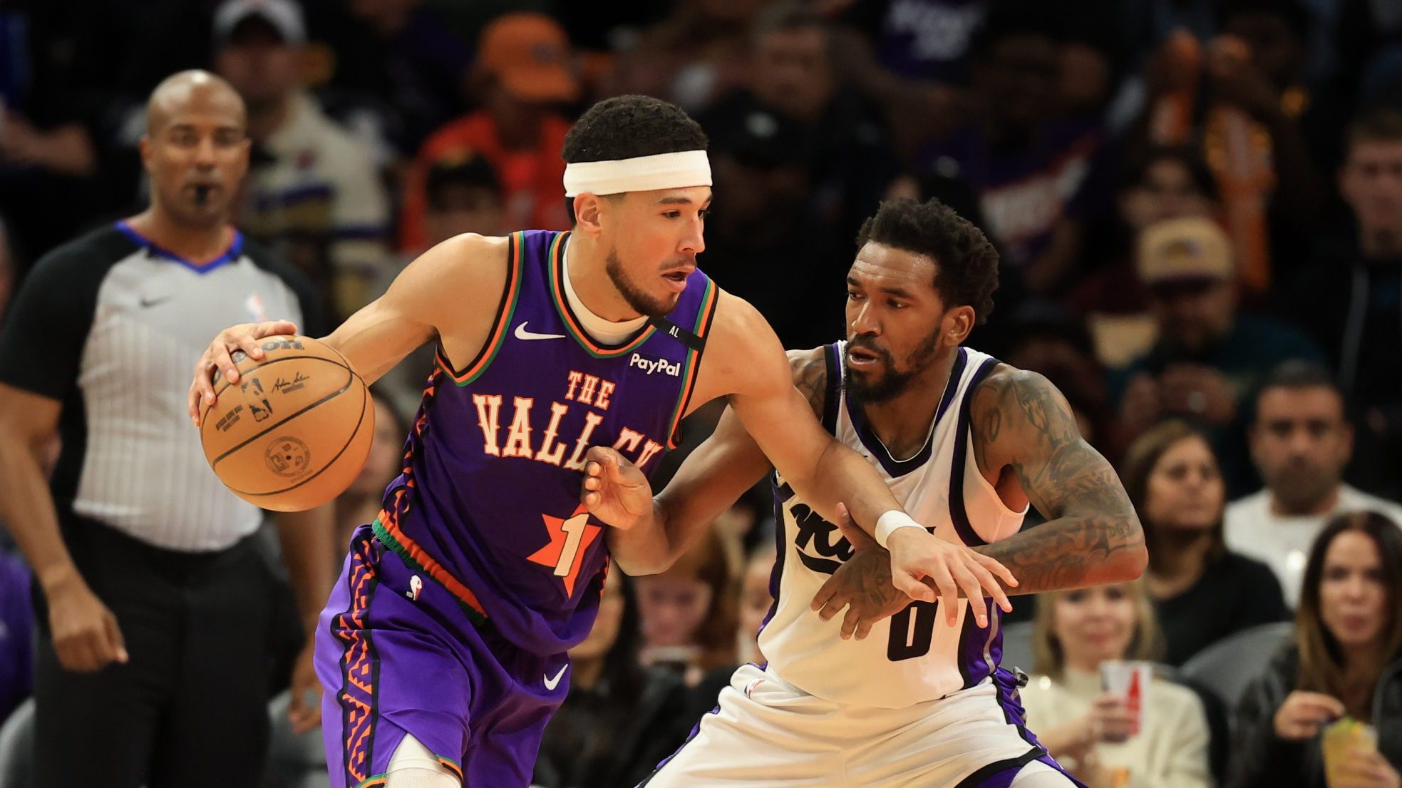 Mar 14, 2025; Phoenix, Arizona, USA; Phoenix Suns guard Devin Booker (1) against Sacramento Kings guard Malik Monk (0) at Footprint Center. Mandatory Credit: Mark J. Rebilas-Imagn Images