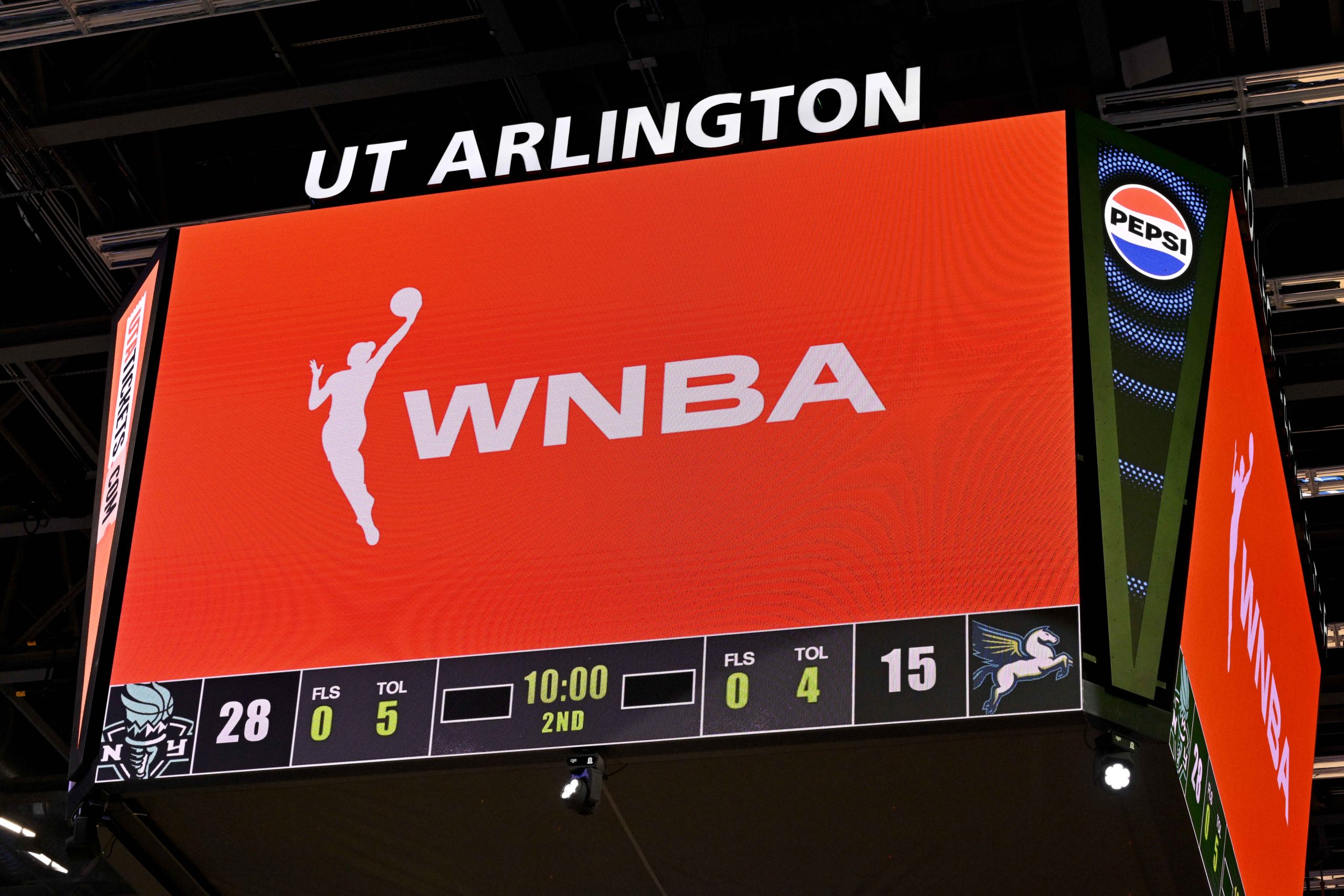 Aug 8, 2025; Arlington, Texas, USA; A view of the scoreboard and the WNBA logo as an announcement is made about throwing any toys or objects on to the court during the first half of the game between the Dallas Wings and the New York Liberty at College Park Center. Mandatory Credit: Jerome Miron-Imagn Images