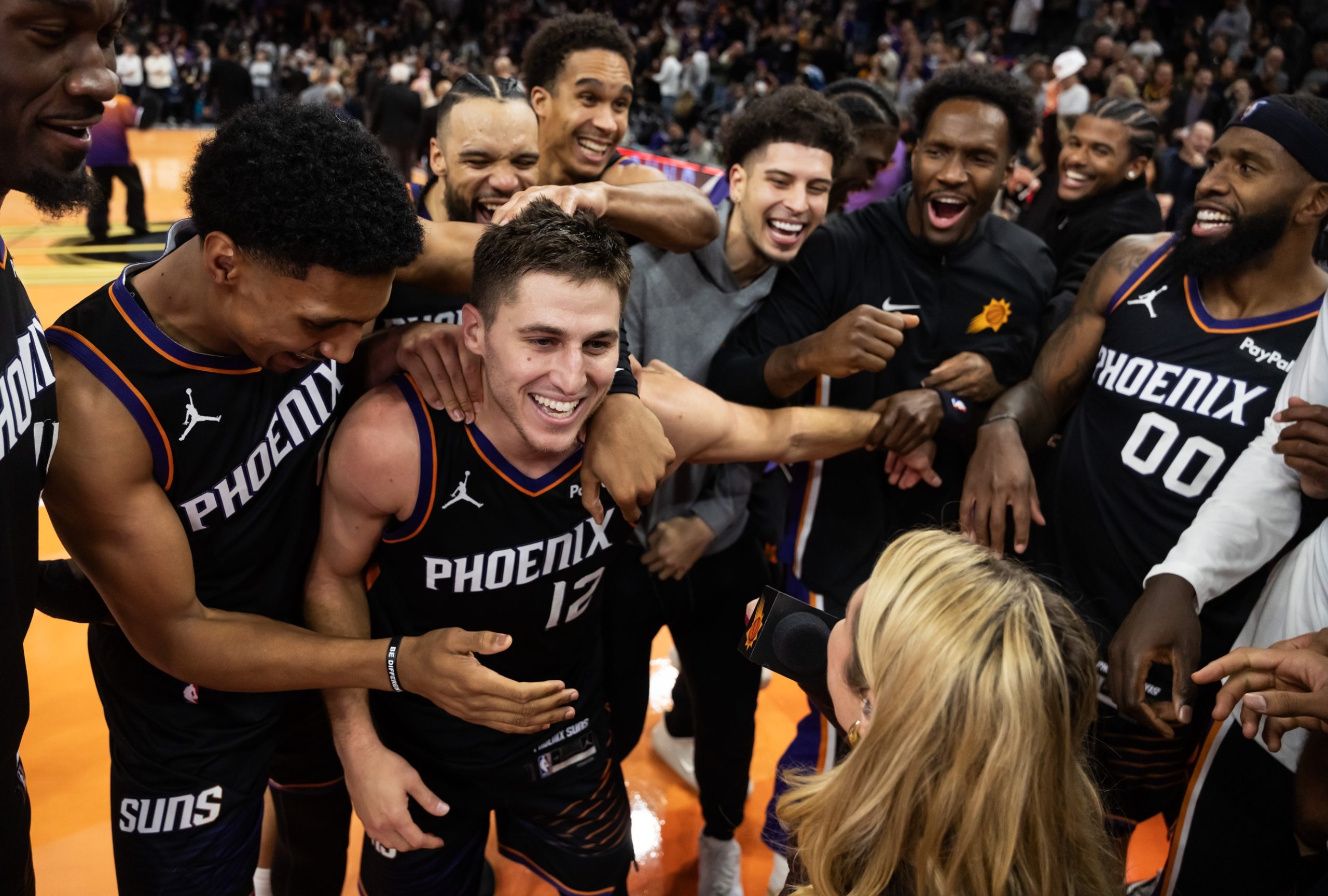 Nov 21, 2025; Phoenix, Arizona, USA; Phoenix Suns guard Collin Gillespie (12) celebrates with teammates after hitting the game winning shot against the Minnesota Timberwolves in the second half of an NBA Cup game at Mortgage Matchup Center. Mandatory Credit: Mark J. Rebilas-Imagn Images