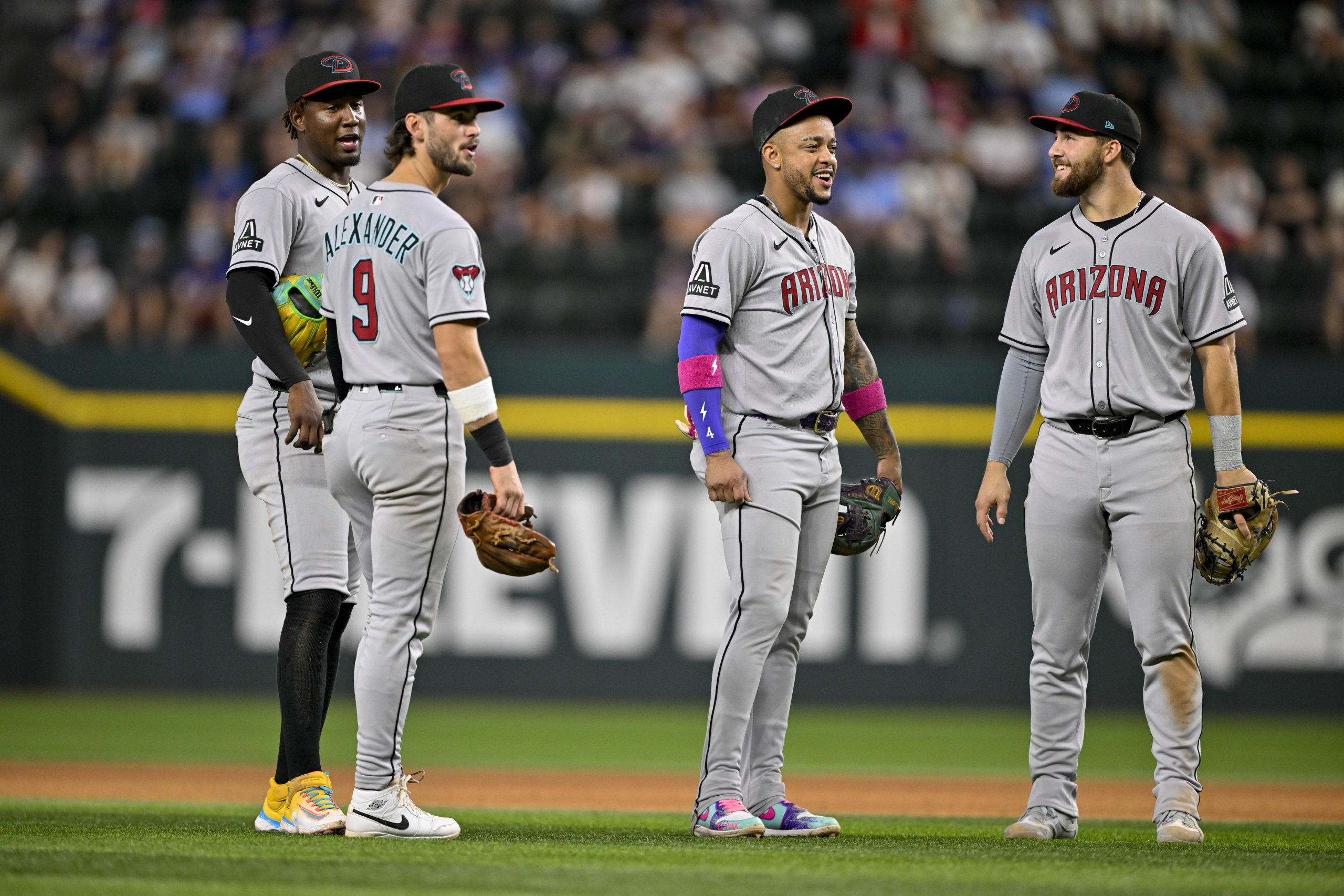 Aug 11, 2025; Arlington, Texas, USA; Arizona Diamondbacks shortstop Geraldo Perdomo (2) and second baseman Ketel Marte (4) and third baseman Blaze Alexander (9) and first baseman Tyler Locklear (28) during the game between the Texas Rangers and the Arizona Diamondbacks at Globe Life Field. Mandatory Credit: Jerome Miron-Imagn Images