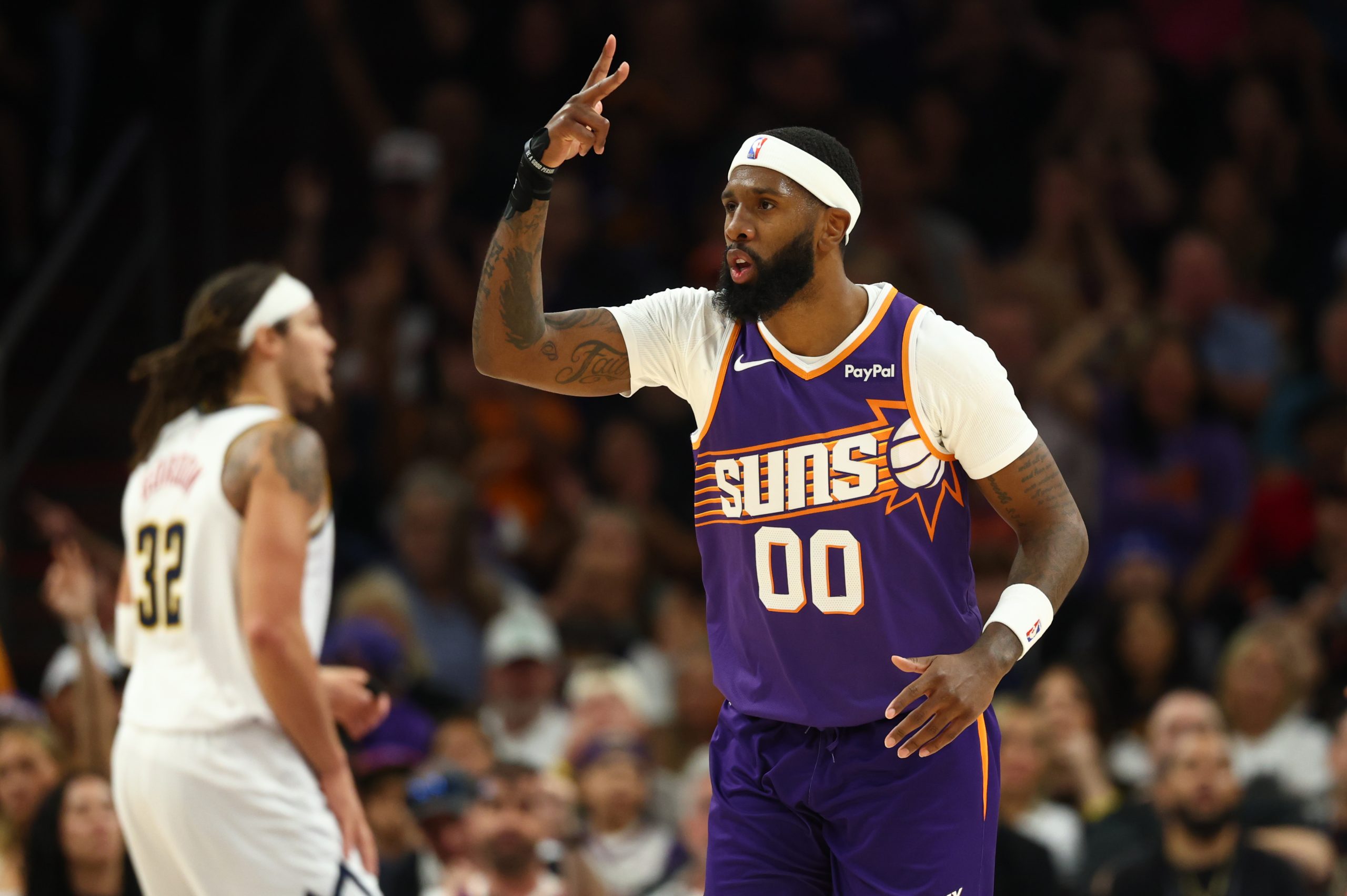 Mar 24, 2026; Phoenix, Arizona, USA; Phoenix Suns forward Royce O'Neale (00) celebrates a three point shot against the Denver Nuggets in the first half at Mortgage Matchup Center. Mandatory Credit: Mark J. Rebilas-Imagn Images