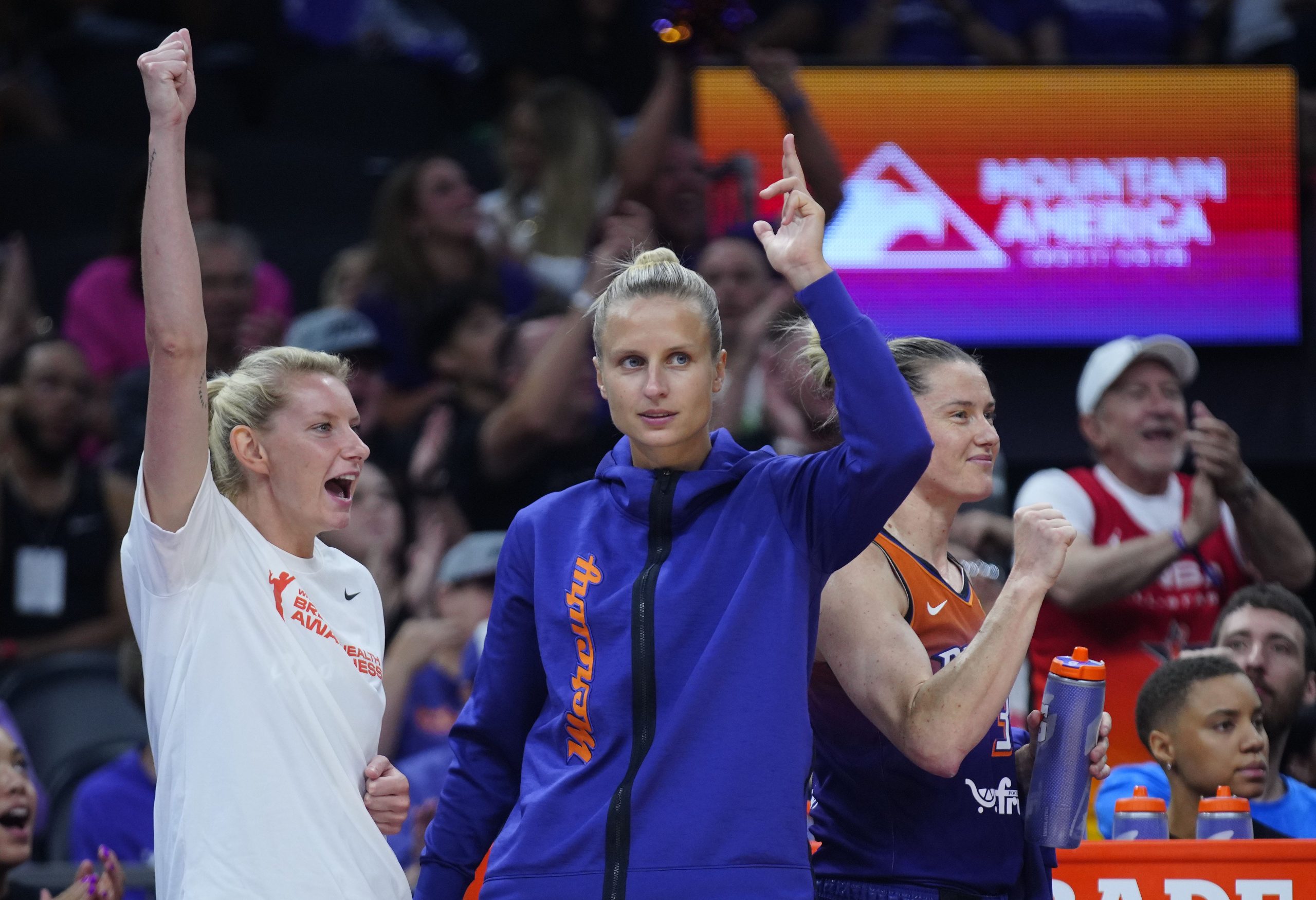 Mercury guards Lexie Held (center white) and Kitija Laska (center purple) celebrate a basket at PHX Arena in Phoenix on Aug. 7, 2025