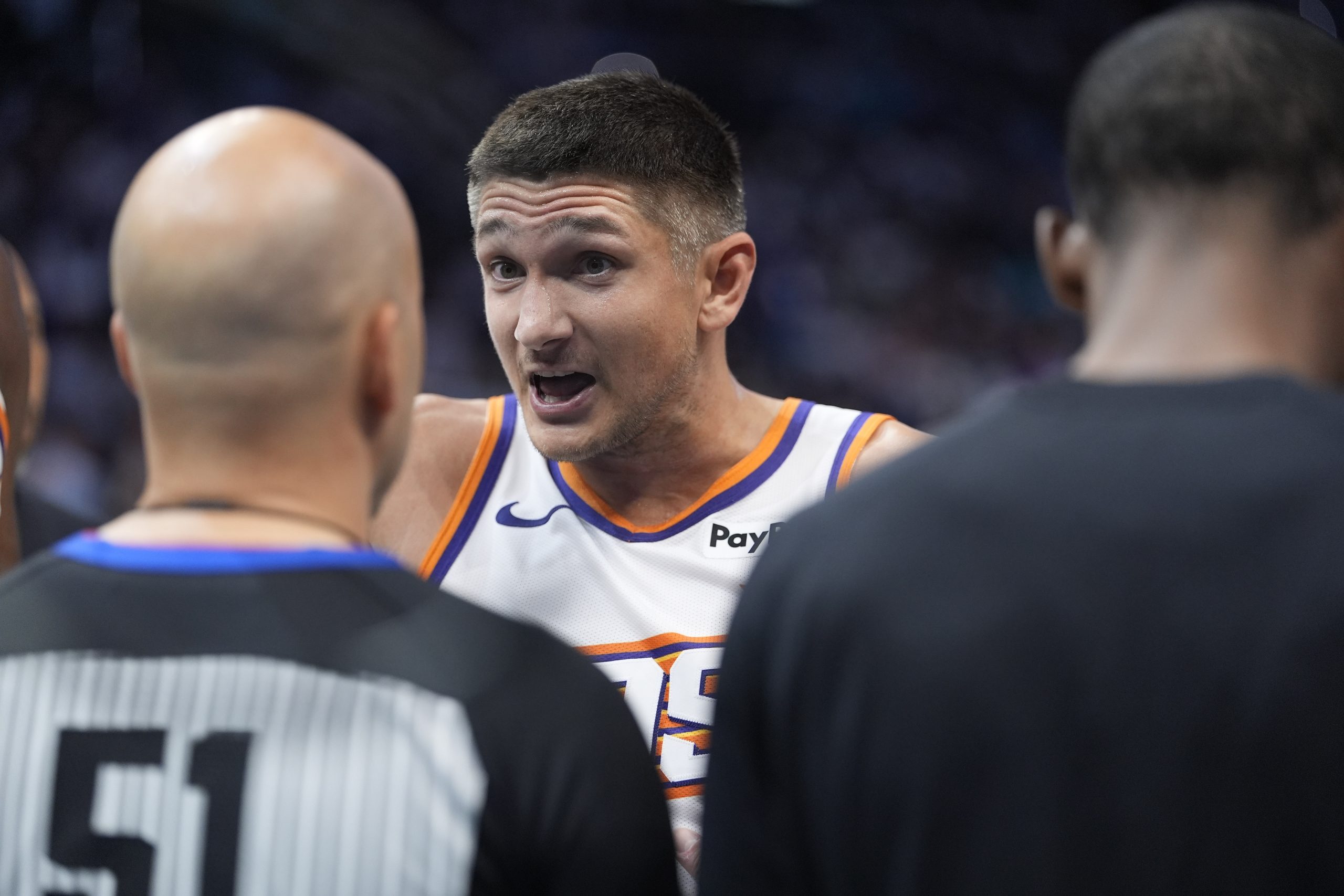 Apr 2, 2026; Charlotte, North Carolina, USA; Phoenix Suns guard Grayson Allen (8) discusses a call with referee Aaron Smith (51) during the second half against the Charlotte Hornets at Spectrum Center. Mandatory Credit: Jim Dedmon-Imagn Images